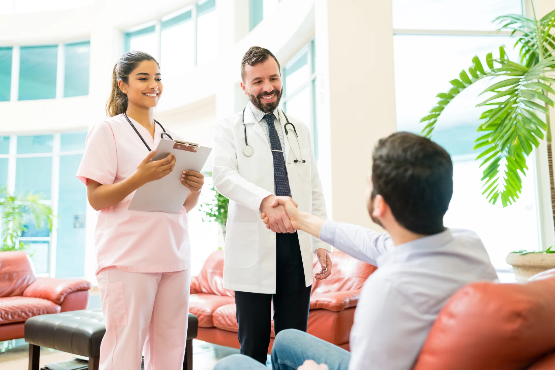 Healthcare workers greet a man