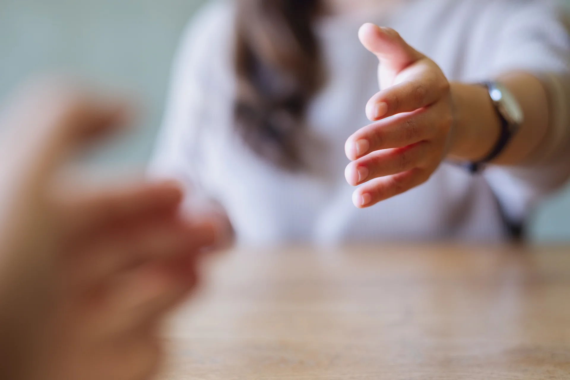 Outstretched hand reaching out for connection and support, symbolizing assistance in addiction intervention and recovery.